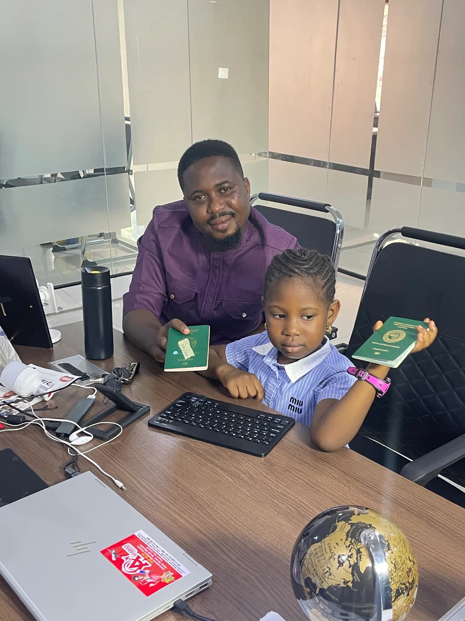 A client and child holding their travel documents